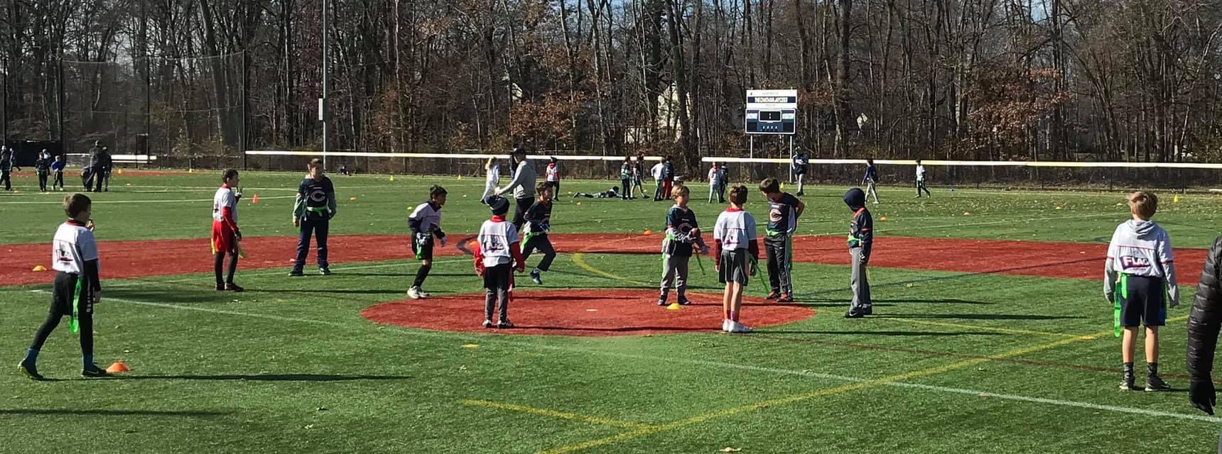 Flag football players line up for a play on the turf